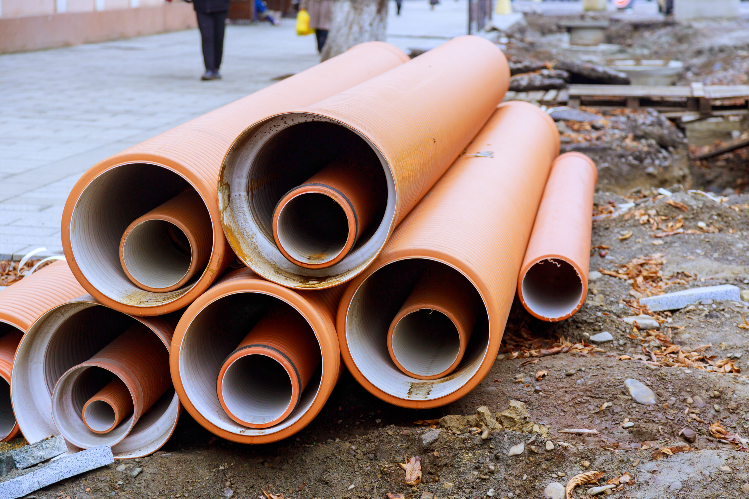 Sewer pipes made of HDPE polyethylene awaiting installation as backbone of a new infrastructure project